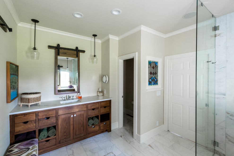 Inspiration for a mid-sized country master bathroom in Charlotte with shaker cabinets, dark wood cabinets, a corner shower, gray tile, marble, beige walls, marble floors, an undermount sink, marble benchtops, grey floor, an open shower and white benchtops.