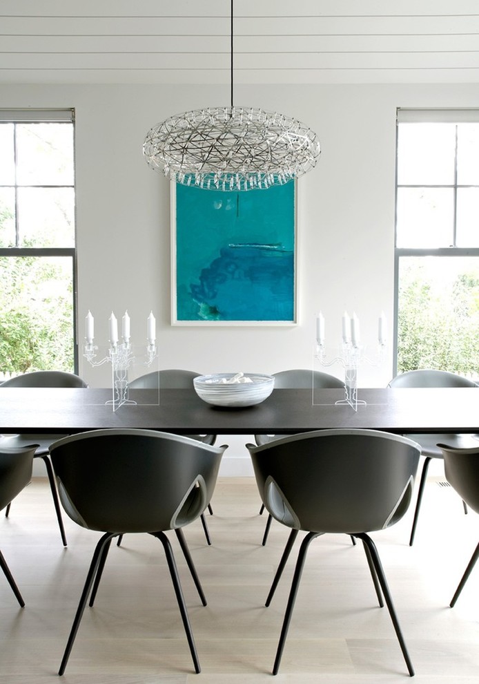 Photo of a contemporary dining room in Chicago with white walls and white floor.