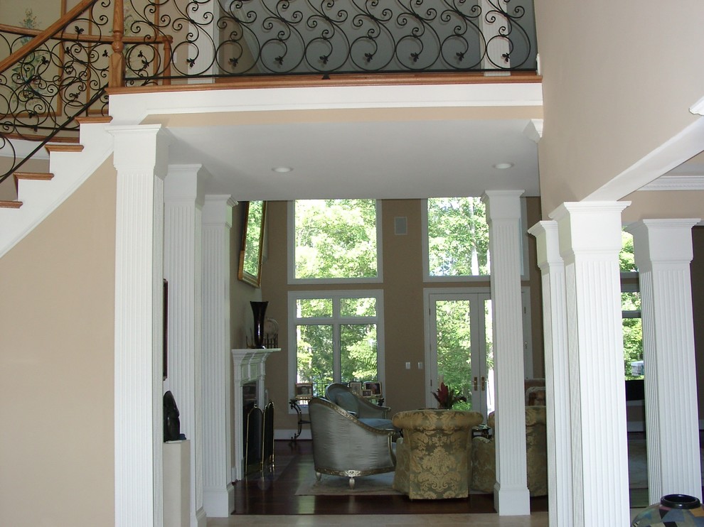 This is an example of an expansive traditional foyer in Raleigh with beige walls, a double front door, a white front door and porcelain floors.