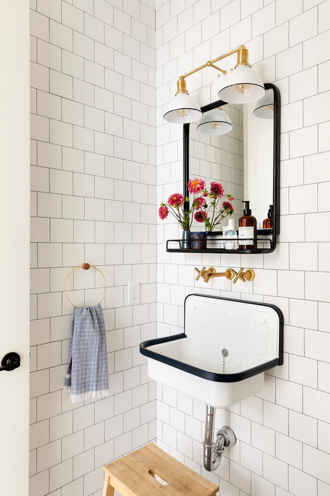 This is an example of a country powder room in Minneapolis with white tile, white walls and a wall-mount sink.