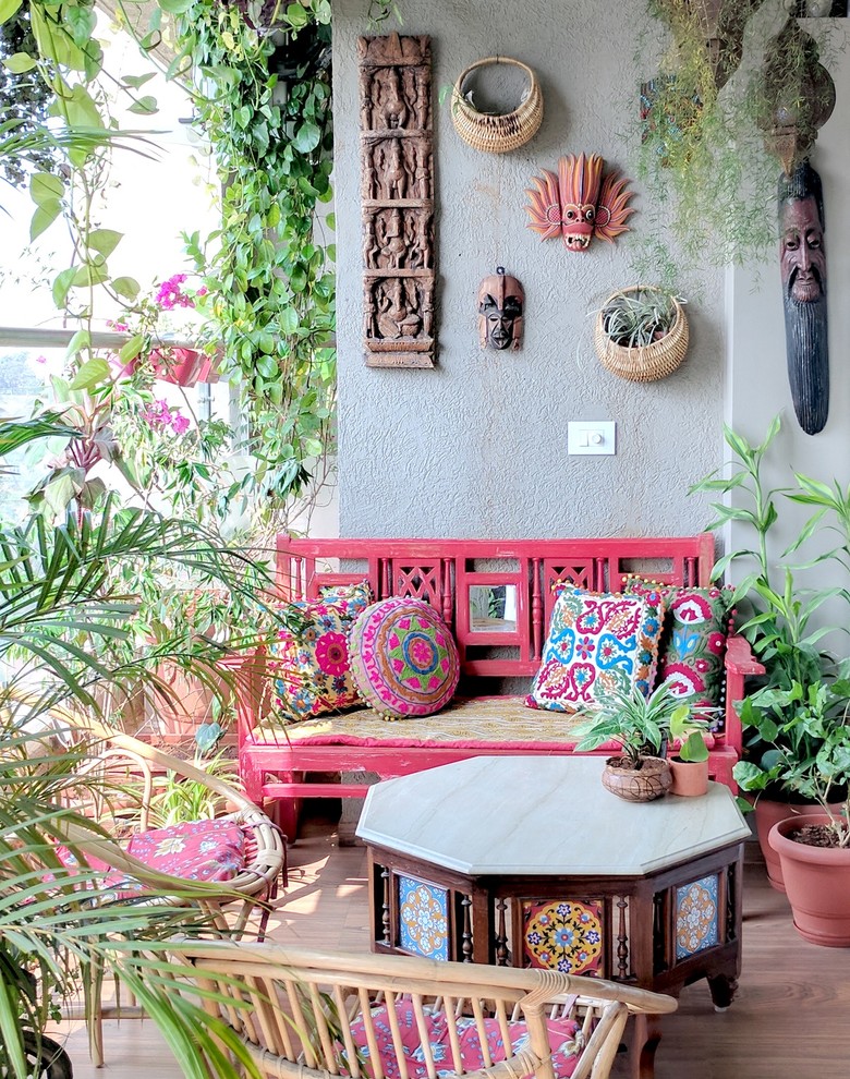 This is an example of an eclectic balcony in Mumbai with a container garden.
