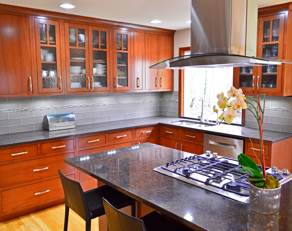 Large transitional l-shaped medium tone wood floor and brown floor open concept kitchen photo in Seattle with an undermount sink, flat-panel cabinets, dark wood cabinets, quartz countertops, gray backsplash, subway tile backsplash, stainless steel appliances and an island