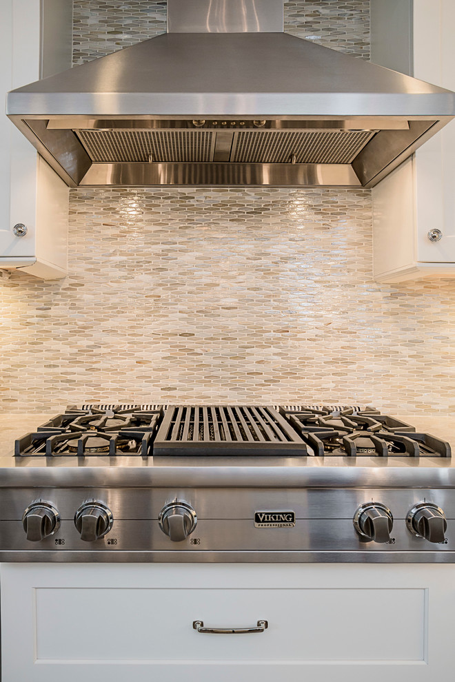 Large transitional galley porcelain tile eat-in kitchen photo in Chicago with a farmhouse sink, shaker cabinets, white cabinets, quartzite countertops, multicolored backsplash, glass sheet backsplash, stainless steel appliances and an island