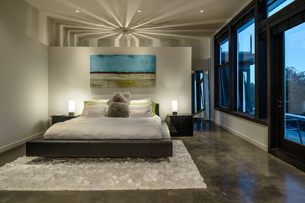 Contemporary bedroom in Vancouver with concrete floors.