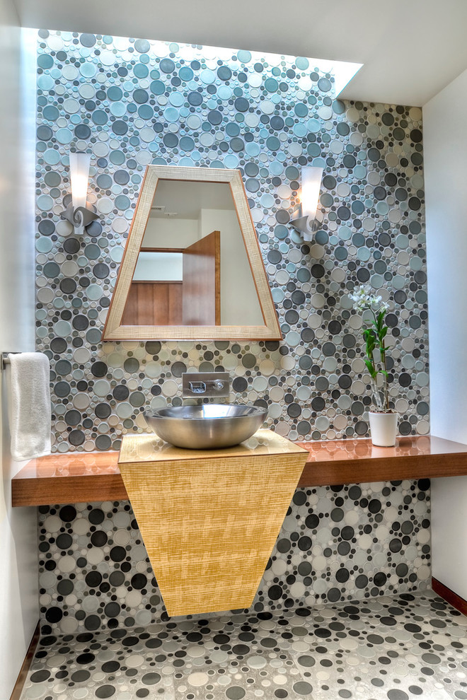 This is an example of a small contemporary powder room in San Diego with a vessel sink, wood benchtops, multi-coloured tile, grey walls, mosaic tile floors, mosaic tile and brown benchtops.