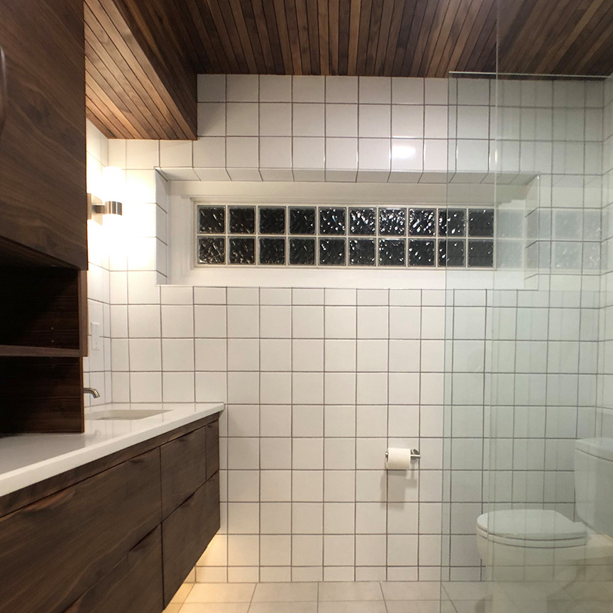 Inspiration for a small midcentury master bathroom in Detroit with flat-panel cabinets, dark wood cabinets, a curbless shower, white tile, ceramic tile, porcelain floors, an undermount sink, quartzite benchtops, beige floor, an open shower, white benchtops, a single vanity, a floating vanity and wood.