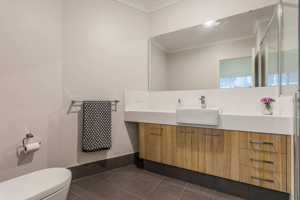This is an example of a contemporary master bathroom in Perth with medium wood cabinets, white tile, grey walls, ceramic floors, an integrated sink and quartzite benchtops.