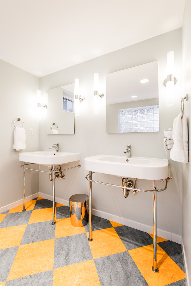 Midcentury bathroom in Boise with a console sink, a freestanding tub and multi-coloured floor.