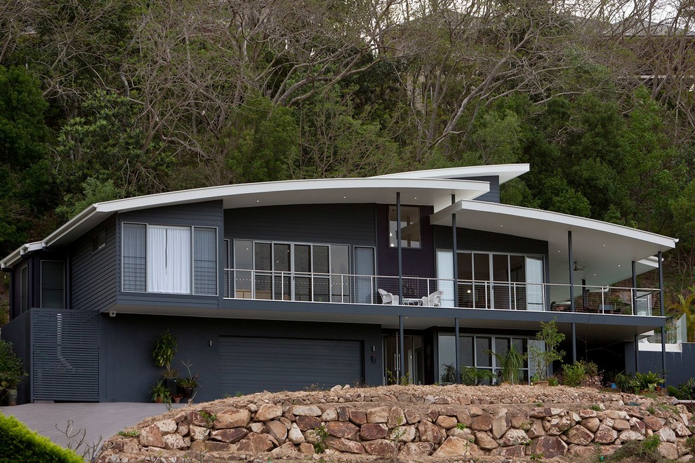 Expansive contemporary two-storey blue exterior in Brisbane with metal siding.