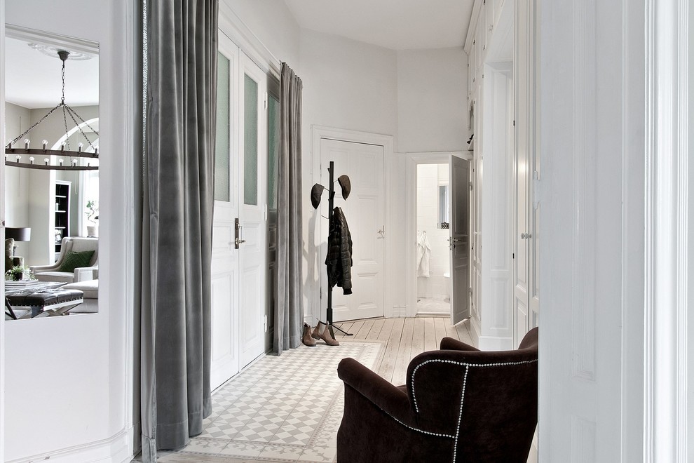 Photo of a mid-sized scandinavian hallway in Other with white walls.