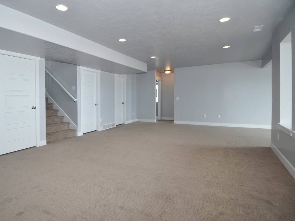 Photo of a mid-sized contemporary walk-out basement in Salt Lake City with grey walls, carpet and no fireplace.