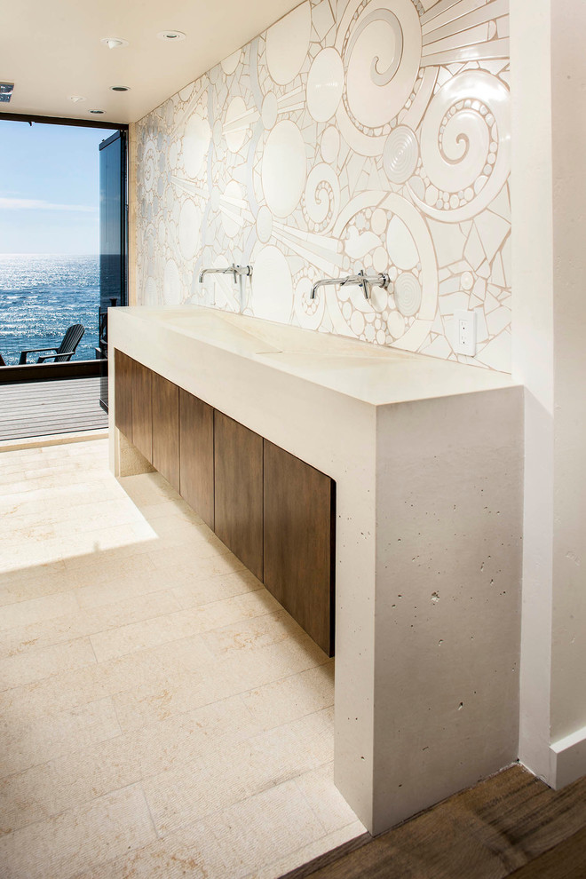 Inspiration for a large contemporary bathroom in San Diego with an integrated sink, flat-panel cabinets, dark wood cabinets, concrete benchtops, an open shower, a bidet, beige tile, ceramic tile, beige walls and concrete floors.
