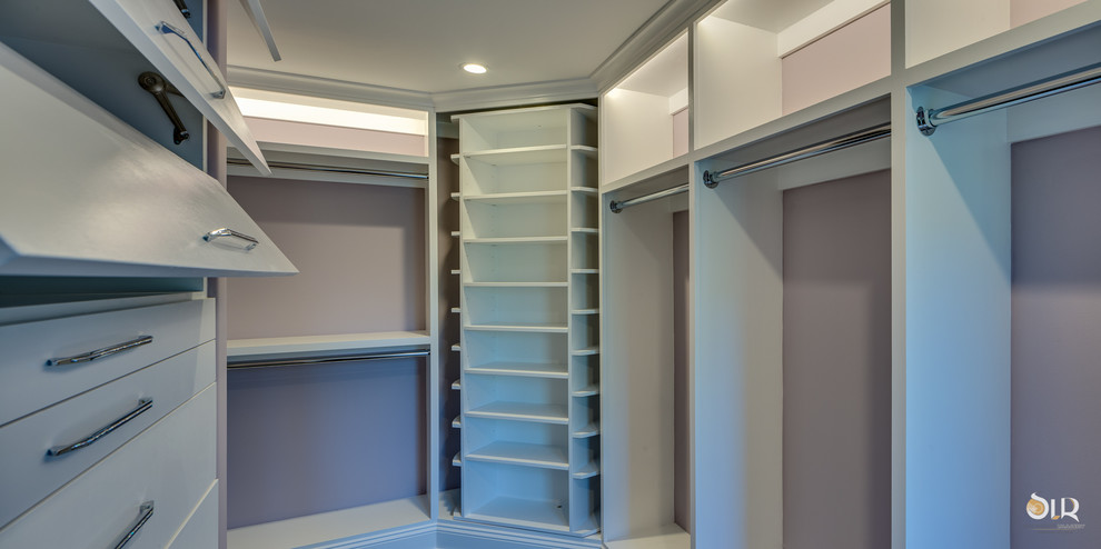 Example of a transitional gender-neutral dark wood floor and brown floor walk-in closet design with open cabinets and white cabinets