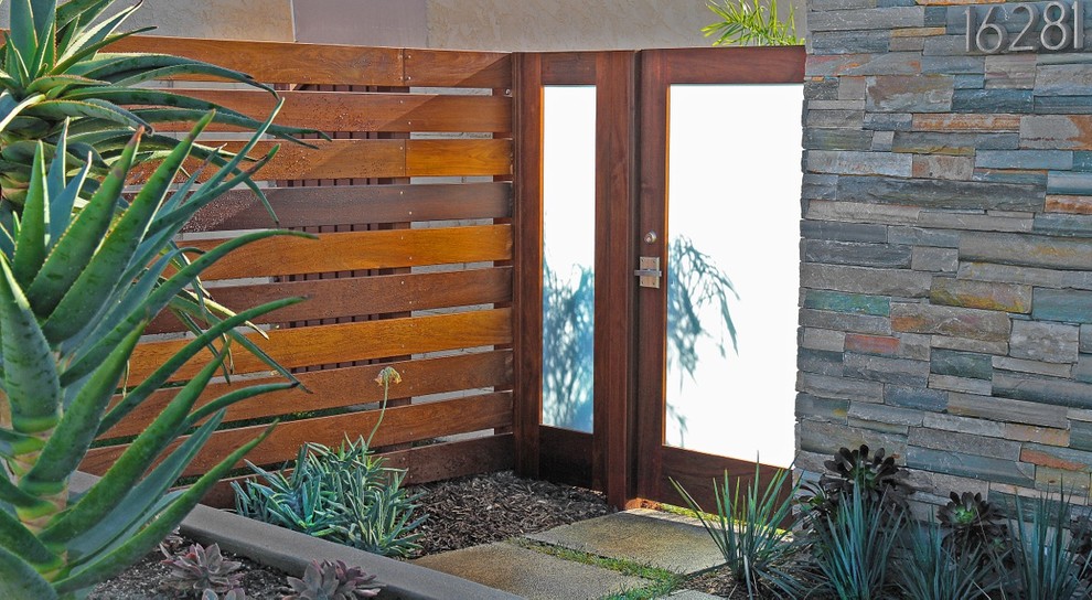 Design ideas for a contemporary front door in Orange County with a single front door and a glass front door.