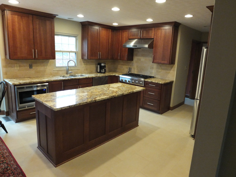 Eat-in kitchen - mid-sized transitional l-shaped ceramic tile eat-in kitchen idea in Columbus with an undermount sink, shaker cabinets, brown cabinets, granite countertops, beige backsplash, ceramic backsplash, stainless steel appliances and an island