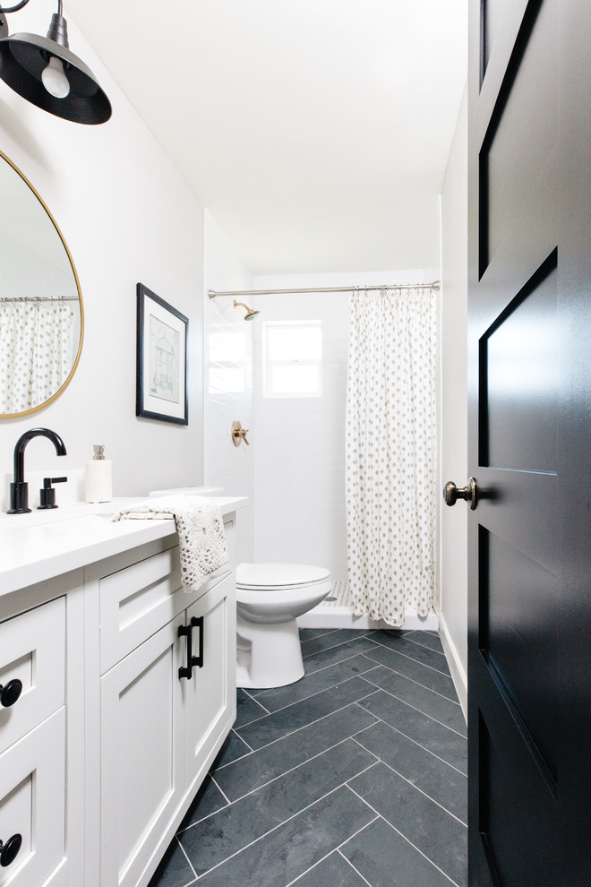 Alcove shower - transitional 3/4 white tile and subway tile slate floor and black floor alcove shower idea in Phoenix with shaker cabinets, white cabinets, white walls and an undermount sink