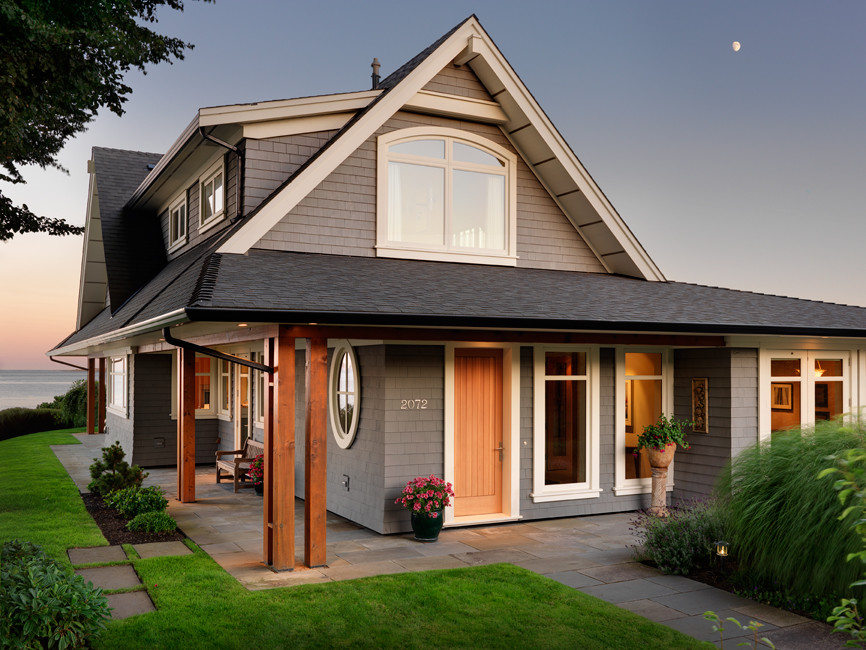 Inspiration for a transitional beige two-story wood gable roof remodel with a shingle roof