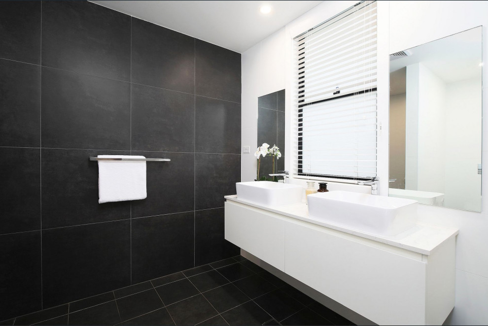 Inspiration for a large contemporary 3/4 bathroom in Central Coast with white cabinets, porcelain floors, black floor, a double vanity, flat-panel cabinets, black tile, porcelain tile, white walls, a vessel sink, white benchtops and a floating vanity.
