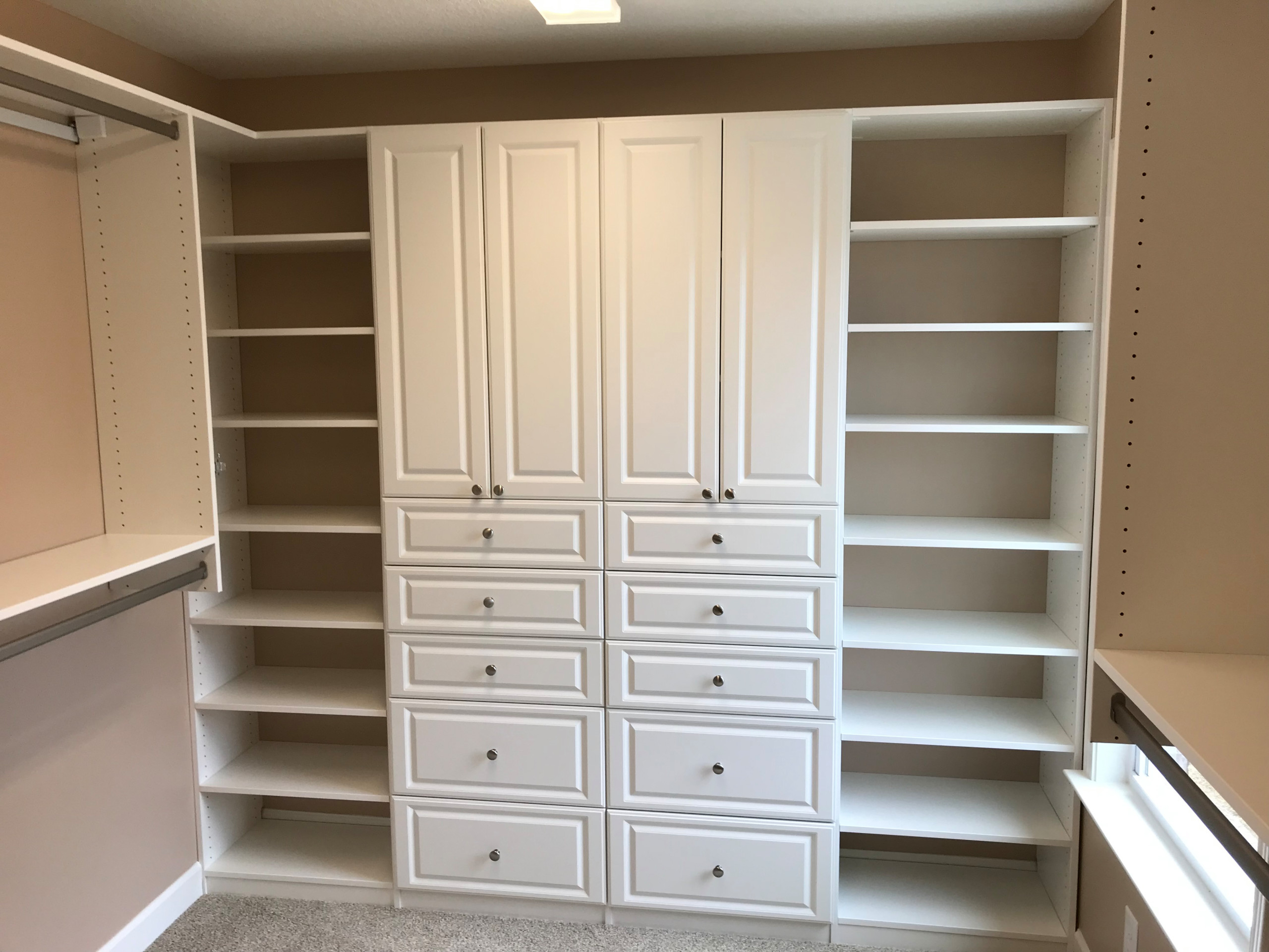 Primary Closet with Raised Panel Cabinets and Drawers