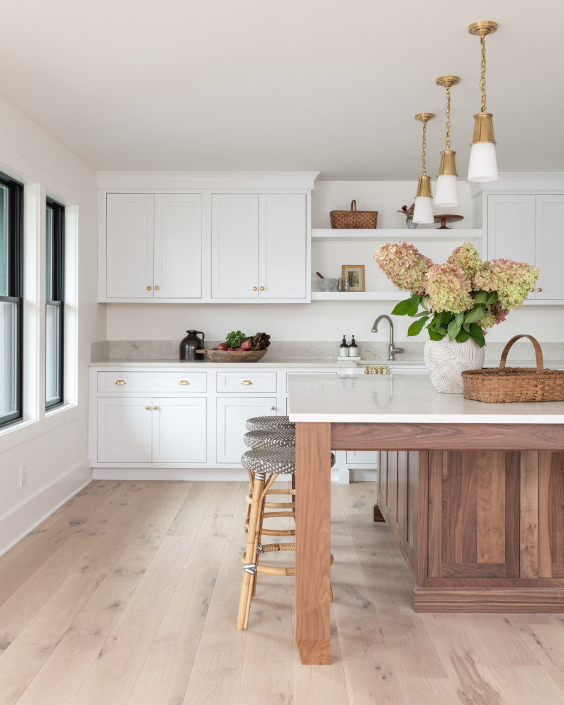 Inspiration for a country kitchen in Boston with a farmhouse sink, shaker cabinets, white cabinets, quartz benchtops and beige benchtop.