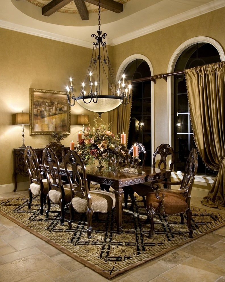 This is an example of a large mediterranean open plan dining in Orlando with beige walls and travertine floors.