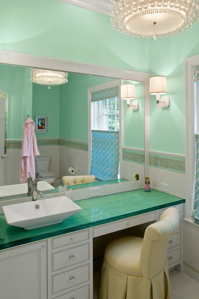 Transitional bathroom in Cincinnati with a vessel sink, white cabinets, white tile, green walls and green benchtops.