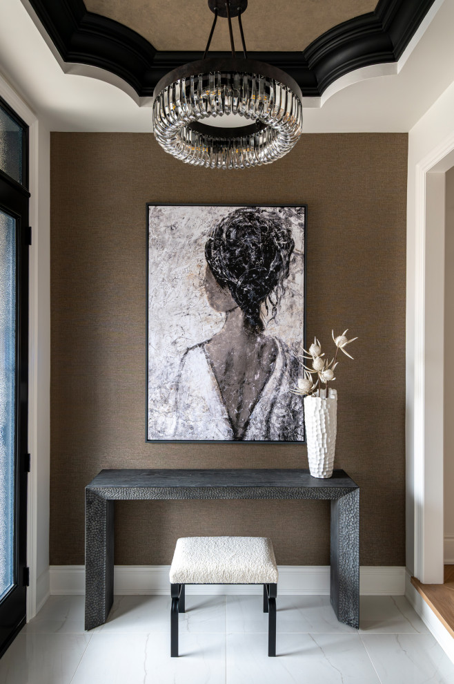 Inspiration for a mid-sized transitional porcelain tile, tray ceiling, wallpaper and white floor foyer remodel in Toronto with brown walls and a glass front door