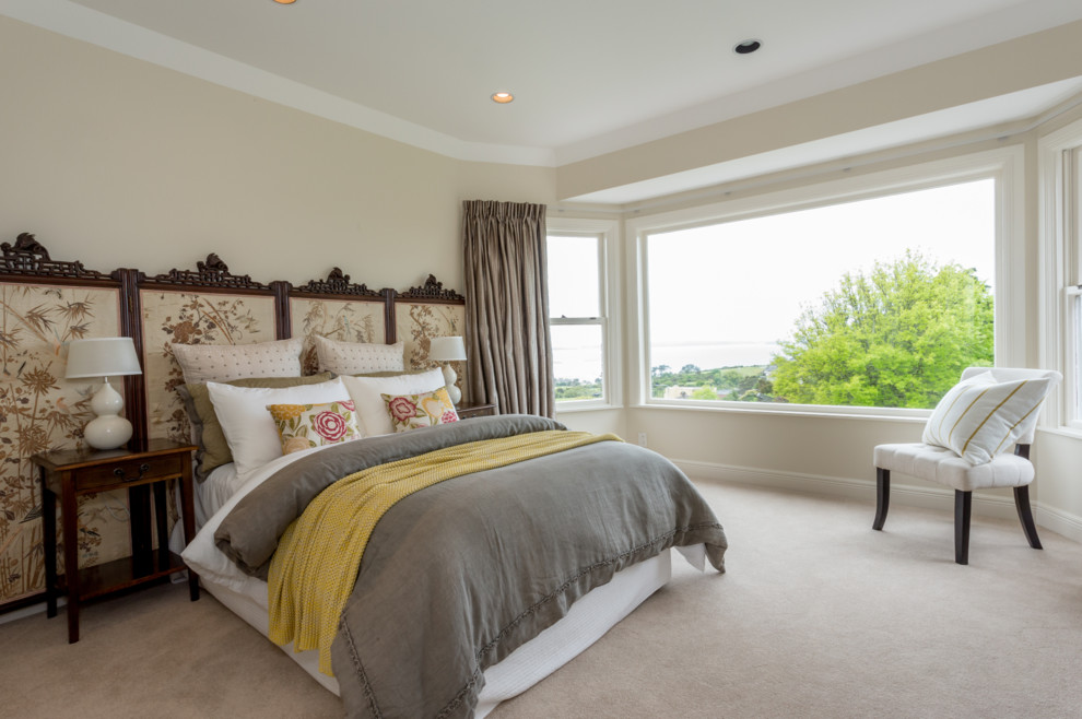 Photo of a mid-sized eclectic master bedroom in Auckland with carpet, no fireplace and beige floor.