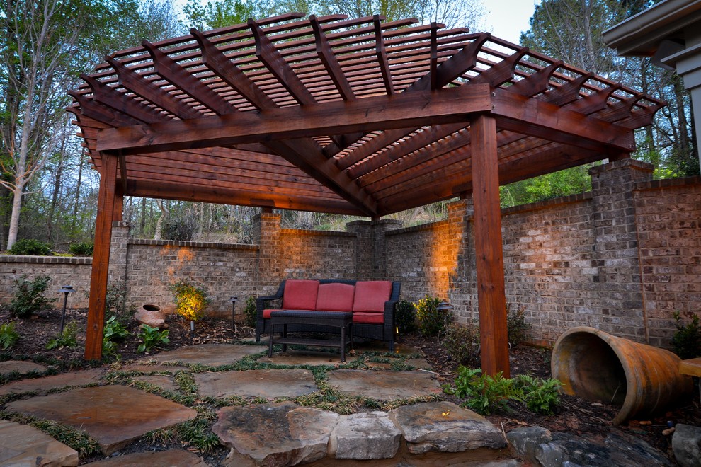 This is an example of an expansive country backyard patio in Atlanta with brick pavers.