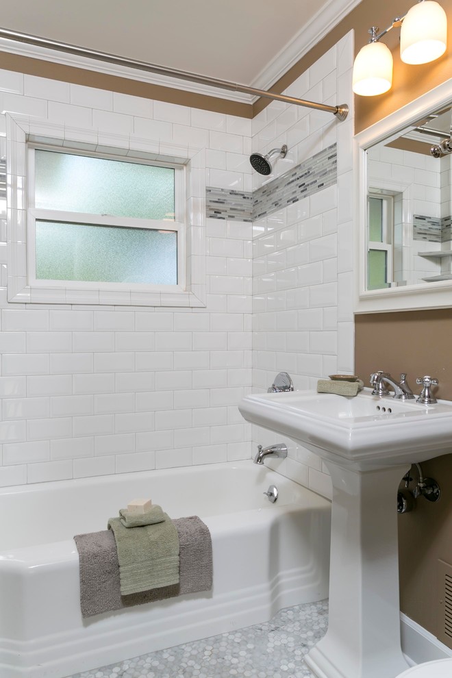Photo of a small contemporary kids bathroom in Portland with a pedestal sink, a drop-in tub, a shower/bathtub combo, a two-piece toilet, white tile, porcelain tile, brown walls and mosaic tile floors.