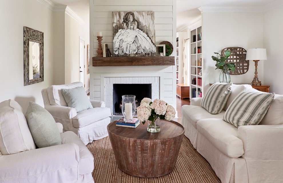 Design ideas for a transitional living room in Charlotte with white walls, medium hardwood floors and a brick fireplace surround.