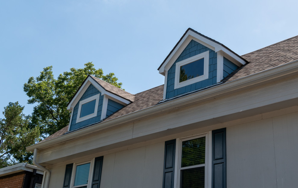 Inspiration for a small traditional two-storey blue apartment exterior in Houston with concrete fiberboard siding, a gable roof, a shingle roof, a grey roof and shingle siding.