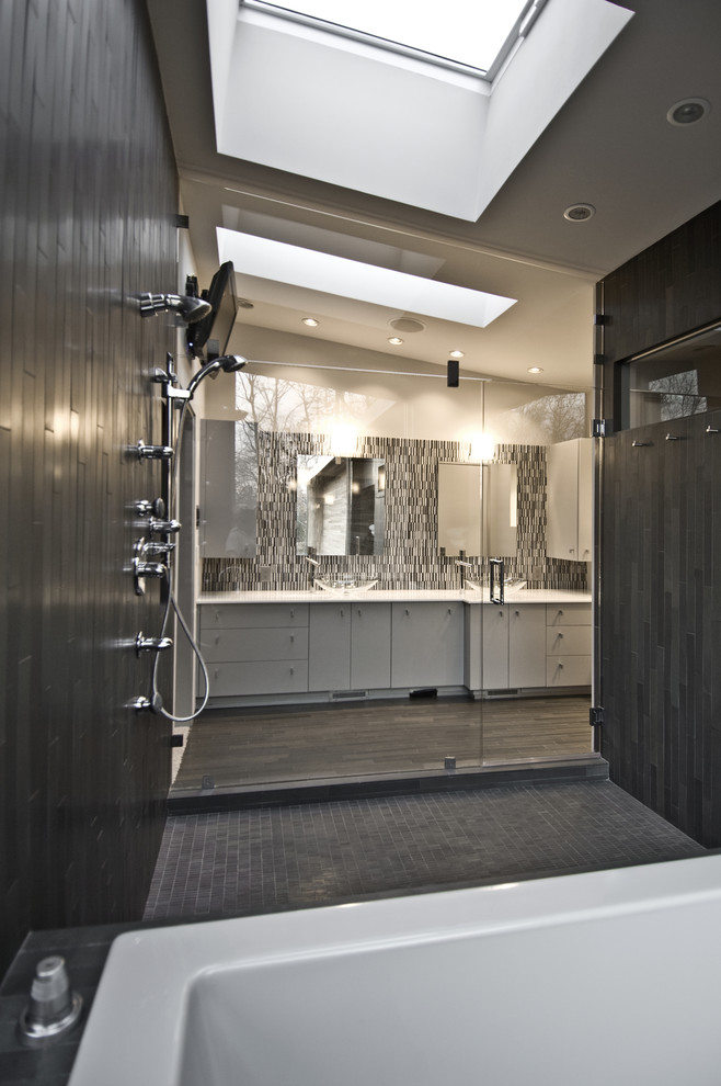 Design ideas for a mid-sized modern master bathroom in Other with a vessel sink, flat-panel cabinets, white cabinets, a drop-in tub, an open shower, multi-coloured tile, matchstick tile, grey walls and limestone floors.