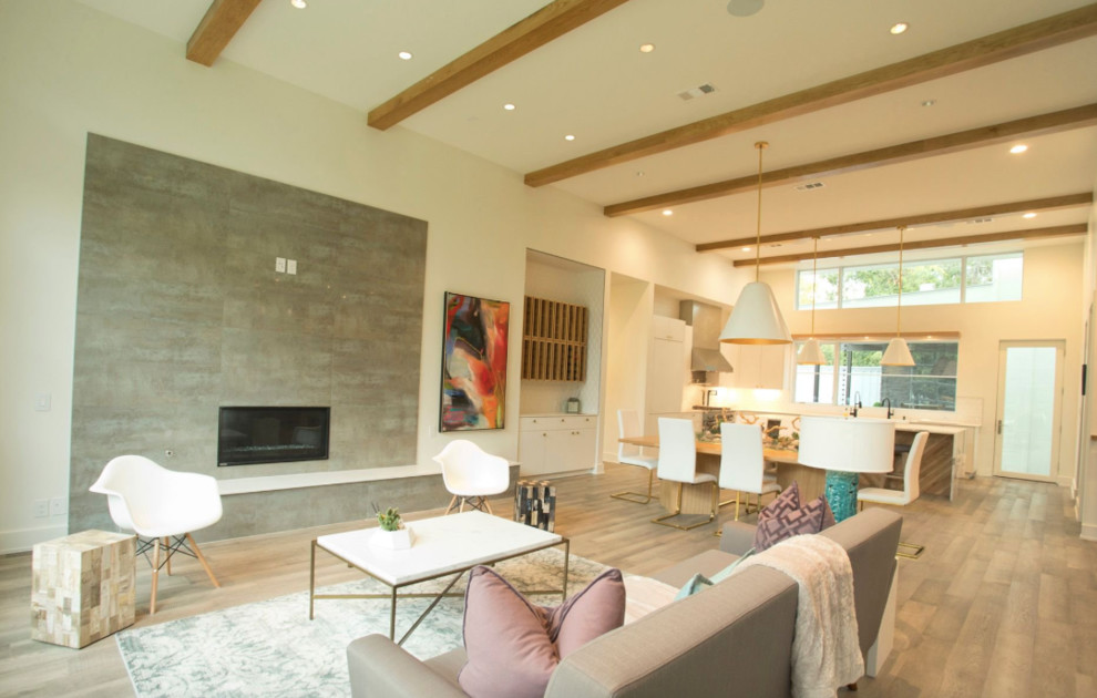 Photo of a large transitional open concept living room in Dallas with brown floor, beige walls, vinyl floors, a standard fireplace and a concrete fireplace surround.