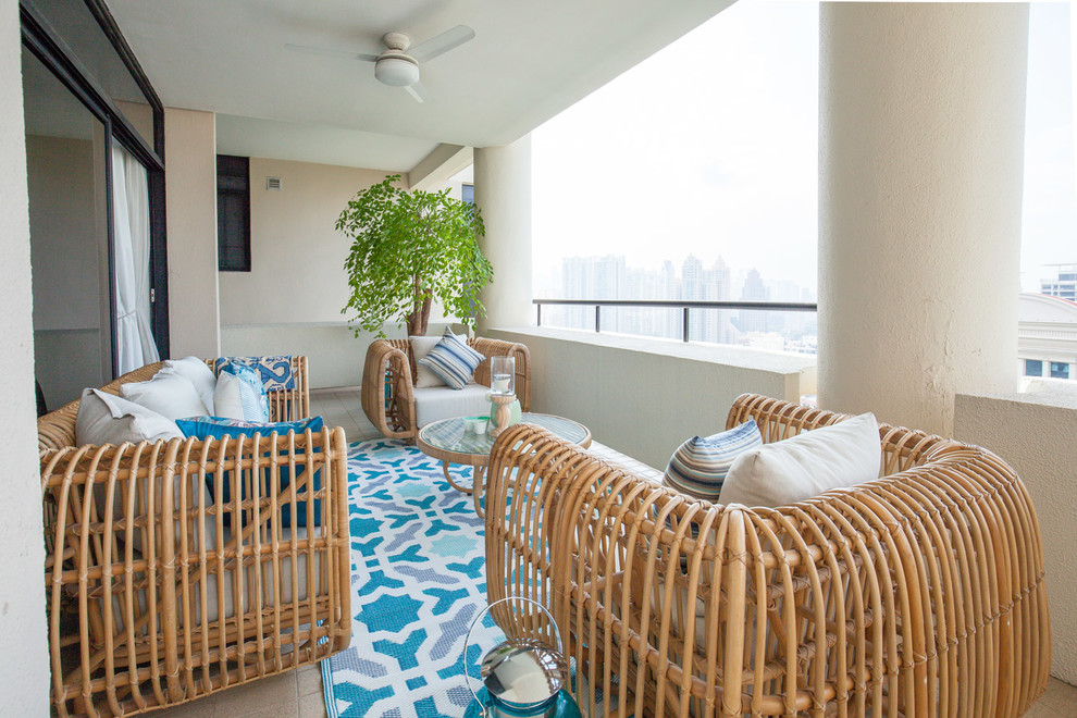This is an example of a mid-sized beach style balcony in Singapore with a roof extension.