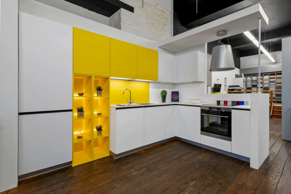 Example of a small l-shaped dark wood floor and brown floor enclosed kitchen design in Other with a drop-in sink, flat-panel cabinets, white cabinets, laminate countertops, yellow backsplash, metal backsplash, stainless steel appliances, no island and white countertops