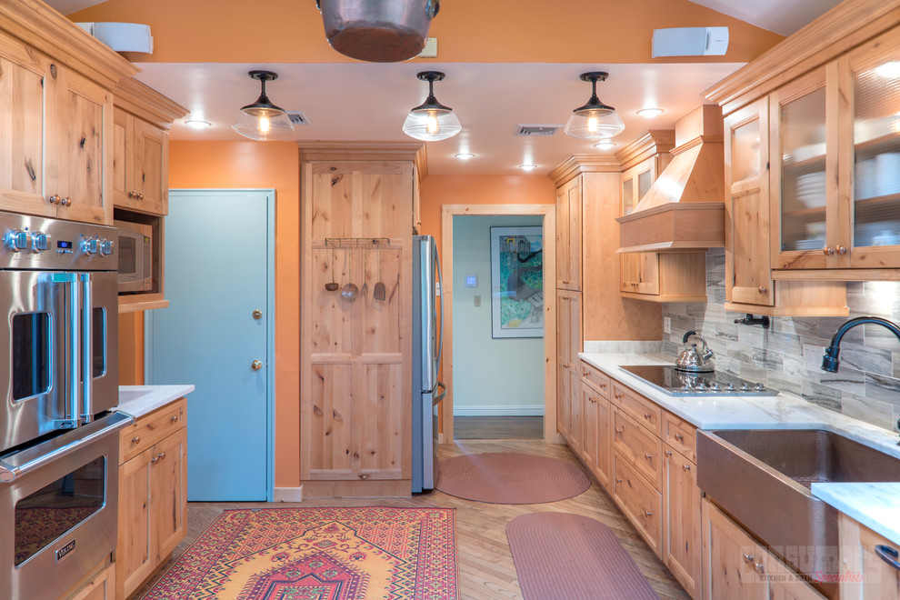 Eat-in kitchen photo in New York with marble countertops and no island