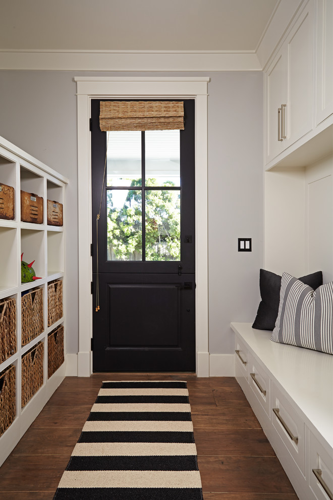 This is an example of a transitional mudroom in Orange County with grey walls, medium hardwood floors, a dutch front door and a black front door.