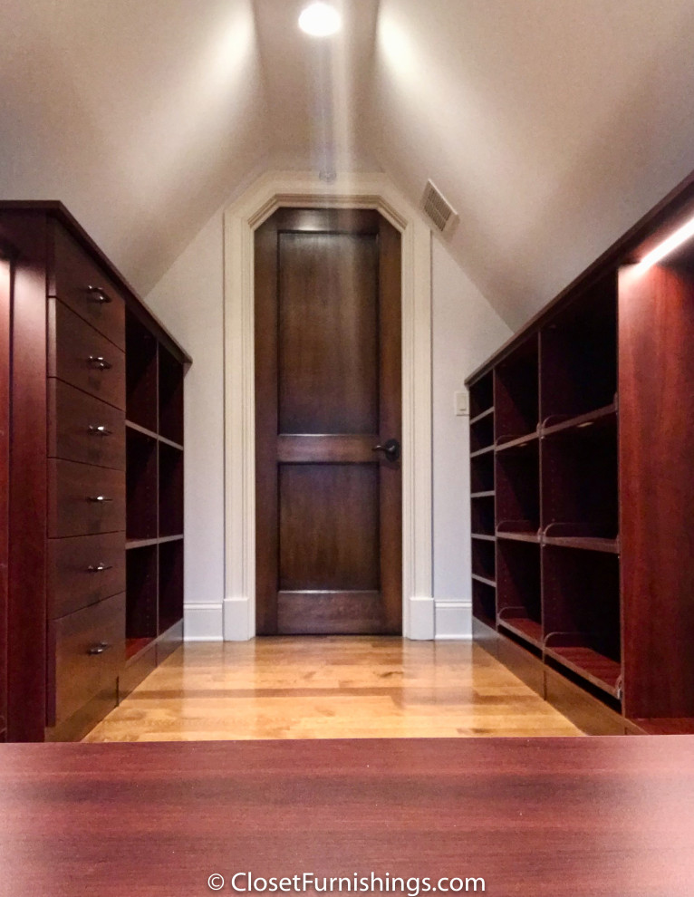 Photo of a mid-sized modern gender-neutral walk-in wardrobe in Chicago with flat-panel cabinets, red cabinets and dark hardwood floors.