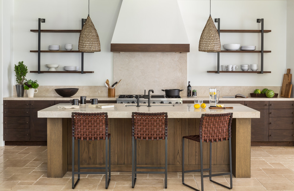 Example of a tuscan galley kitchen design in San Francisco with an undermount sink, flat-panel cabinets, dark wood cabinets, beige backsplash, stainless steel appliances and an island