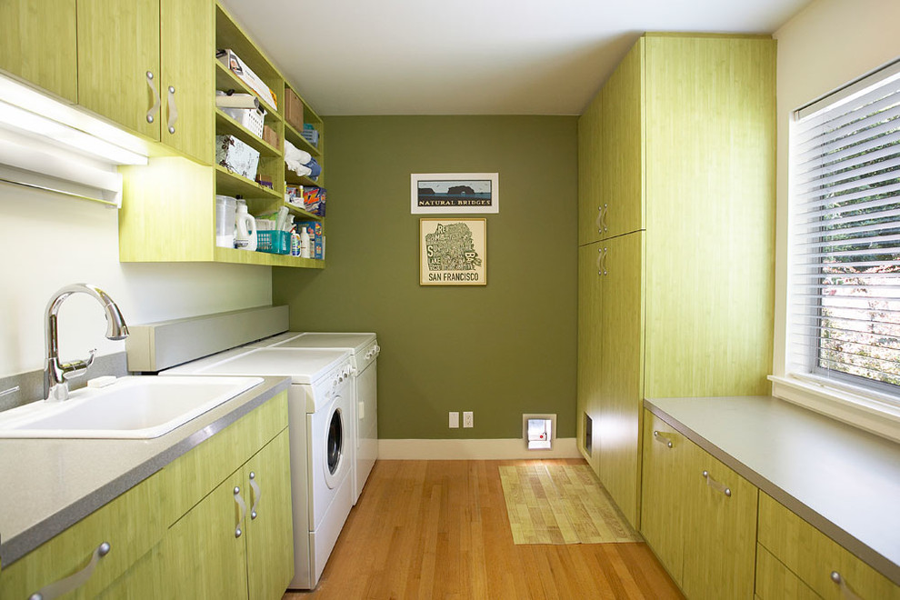 Photo of a contemporary laundry room in San Francisco with green cabinets.
