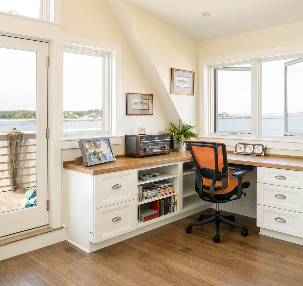 Inspiration for a beach style study room in Portland Maine with medium hardwood floors, a built-in desk and beige walls.
