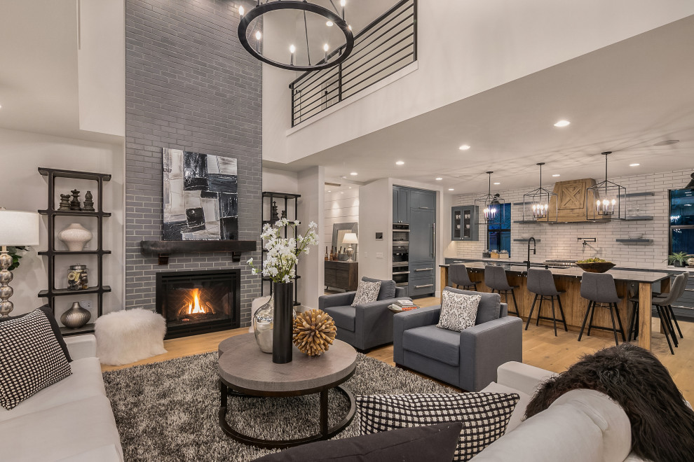 Photo of a large country formal open concept living room in Seattle with white walls, a standard fireplace, no tv, black floor and a brick fireplace surround.
