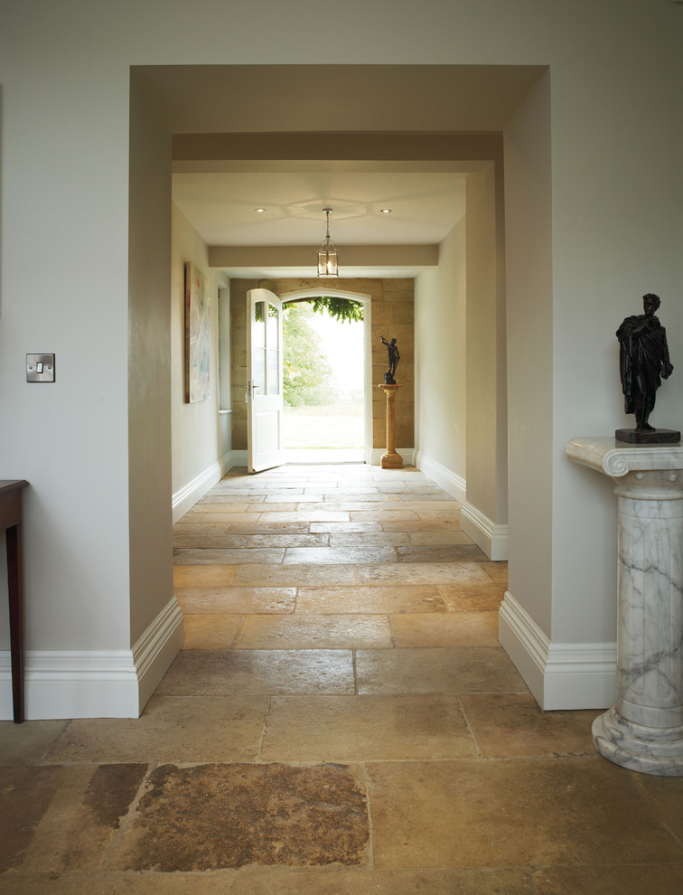 Design ideas for a traditional hallway in Other with limestone floors.