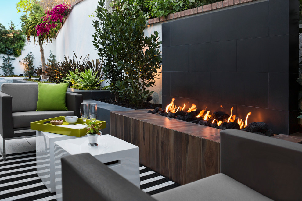 Inspiration for a small contemporary backyard garden in Los Angeles with a fire feature and natural stone pavers.