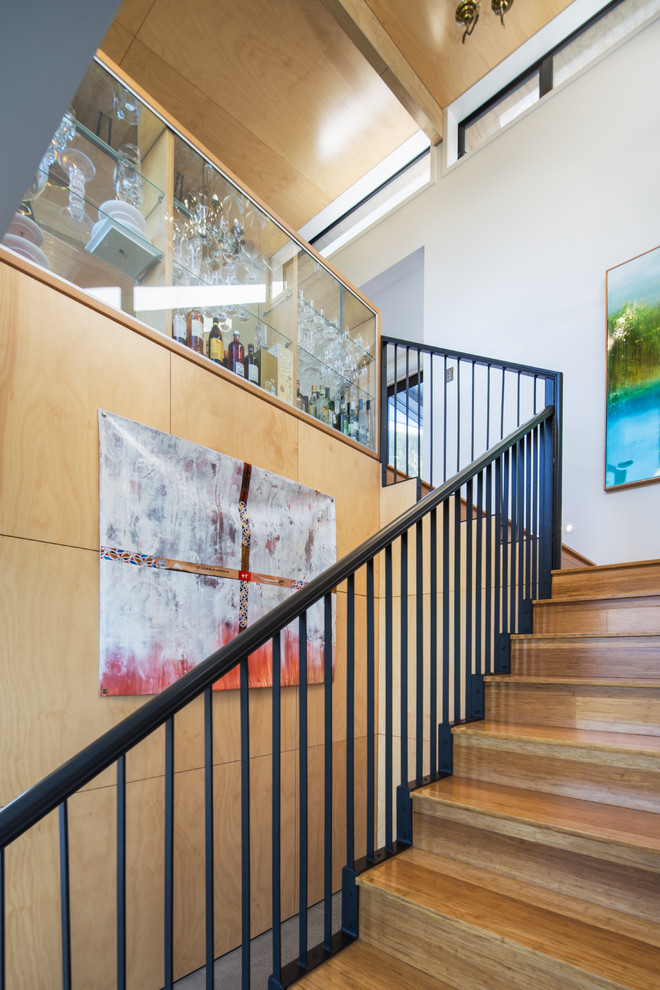 This is an example of a mid-sized contemporary wood l-shaped staircase in Wellington with wood risers.