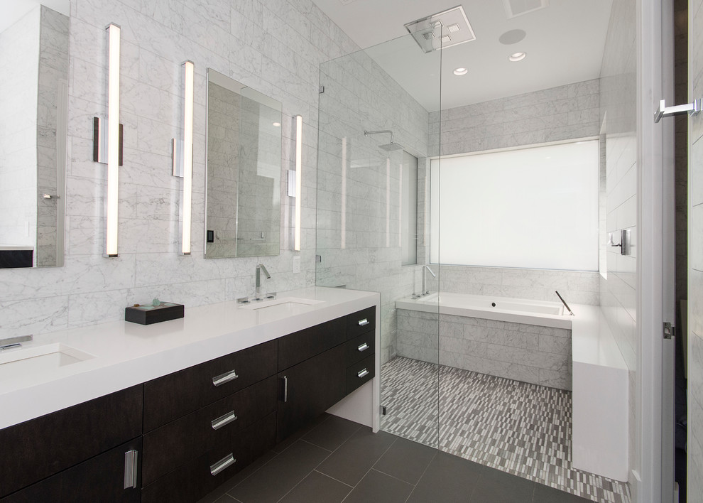 Photo of a mid-sized contemporary master wet room bathroom in Dallas with flat-panel cabinets, dark wood cabinets, an undermount tub, a one-piece toilet, white tile, marble, white walls, porcelain floors, an undermount sink, quartzite benchtops, grey floor and an open shower.