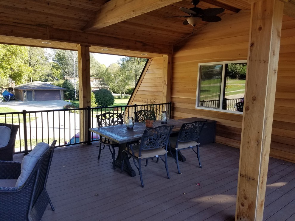 Inspiration for a large backyard deck remodel with a roof extension
