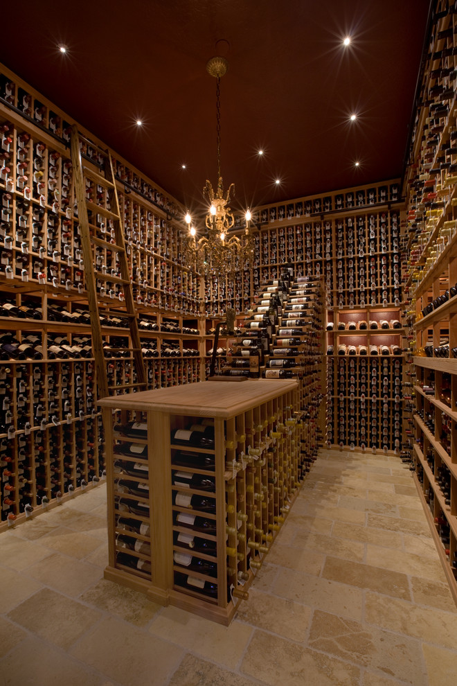 Design ideas for a large traditional wine cellar in Phoenix with storage racks, limestone floors and beige floor.