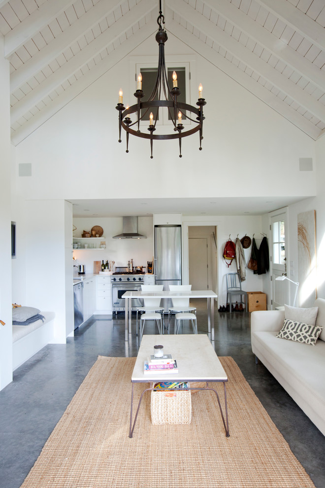 Inspiration for a country open concept living room in Vancouver with white walls and concrete floors.